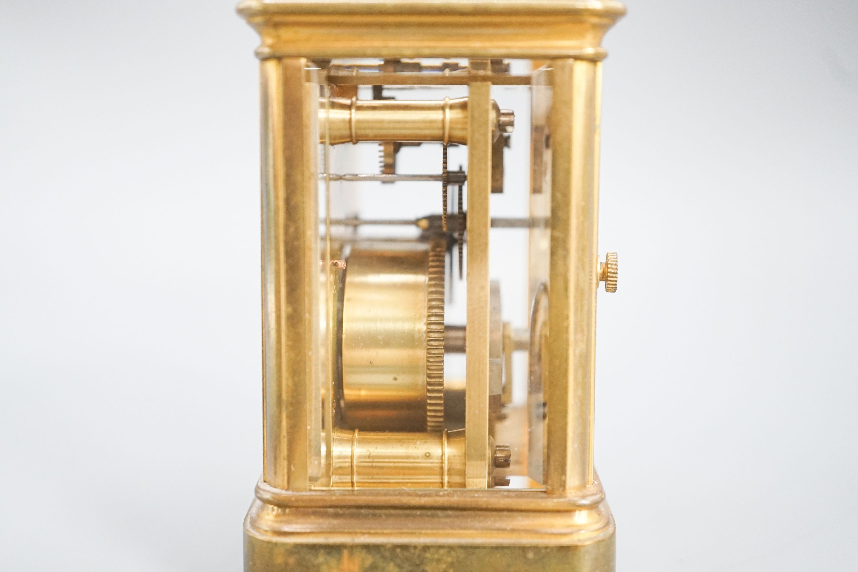 A Henri Jacot brass miniature carriage timepiece, 9.7 cm high with the handle up, cased